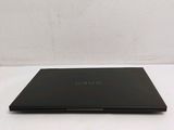 a black laptop sitting on a white surface