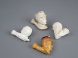 four small figurines of different shapes and sizes on a gray surface