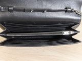 a black purse that is open on a wooden table