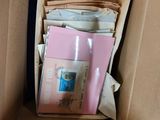 a cardboard box filled with many different types of papers