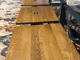 several tables and chairs are lined up in a row in a restaurant