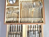 a wooden box with silverware in it on a table