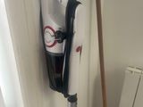 a broom and a mop on the floor next to a radiator