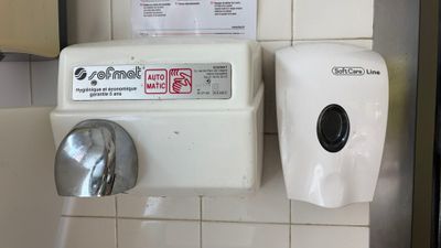 a paper towel dispenser and a paper towel dispenser on the wall
