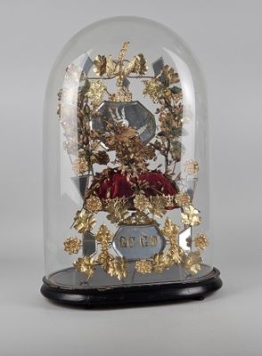a glass dome with a clock inside of it on a table