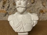 white bust of a man with a beard and mustache on a wooden table