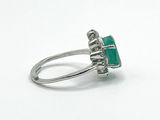 an image of a ring with a green stone in it