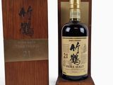 a bottle of japanese whisky sitting on top of a wooden box