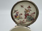 a mirror with a picture of a bird and flowers on it