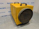 a close up of a yellow air conditioner sitting on top of a floor
