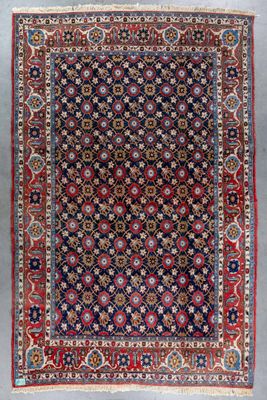 an antique persian rug with blue and red colors