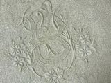an image of a close up of a white towel with a bird on it