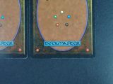 two cards with different designs on them sitting on a table