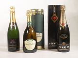 three bottles of champagne are lined up on a white surface