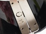 a close up of a black and silver guitar neck