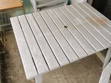 a white table and two chairs on a patio