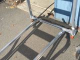 a luggage cart that is sitting on the sidewalk