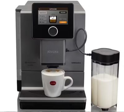 an image of a coffee machine with a glass of milk