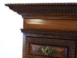 a close up of a wooden cabinet with a clock on top of it