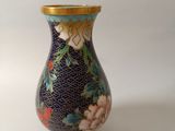 a small vase with a floral design on it