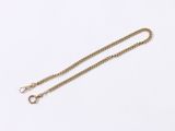 a close up of a gold chain on a white background