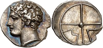 a silver coin with an image of a man ' s head and a cross on it