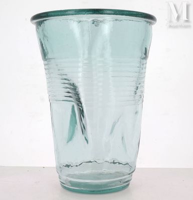 a glass with a toothbrush in it on a table
