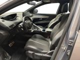 the interior of a car with the door open and the driver ' s seat down