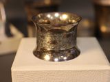 a silver cup sitting on top of a white box