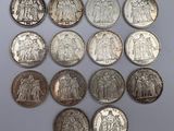 an image of a group of twenty different coins on a white surface