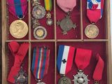 many medals and medals displayed in a wooden box