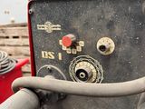 a machine that is sitting in the middle of a pile of wood