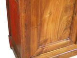 an image of a wooden cabinet with a red door