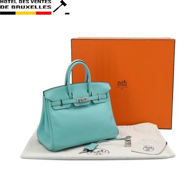 a blue purse sitting on top of a table next to a box