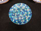 three plates with blue and white designs on them
