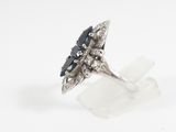 an image of a silver ring with a black stone on it