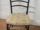 a black chair with a floral seat pad on it