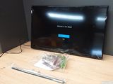 a flat screen tv sitting on top of a wooden table