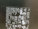 the back side of a laptop with a battery on it ' s side