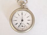 a silver pocket watch with roman numerals on the face