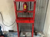 a red fire hydrant sitting on a stand in a garage