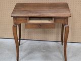 a small wooden table with a drawer on it