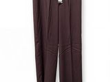 a brown pants hanging on a hanger on a white wall