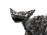 a statue of a dog that is sitting on a table