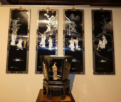 four framed pictures on the wall above a chair