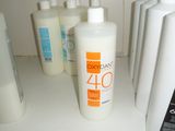 many bottles of lotion sitting on a shelf