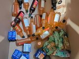 a cardboard box filled with assorted bottles and cans