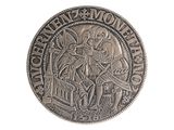 a silver coin with a picture of a man riding a horse