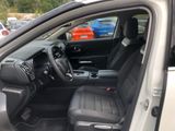 the interior of a car with the door open and the driver ' s seat down