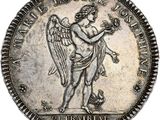 a close up of a silver coin with an angel holding a bird